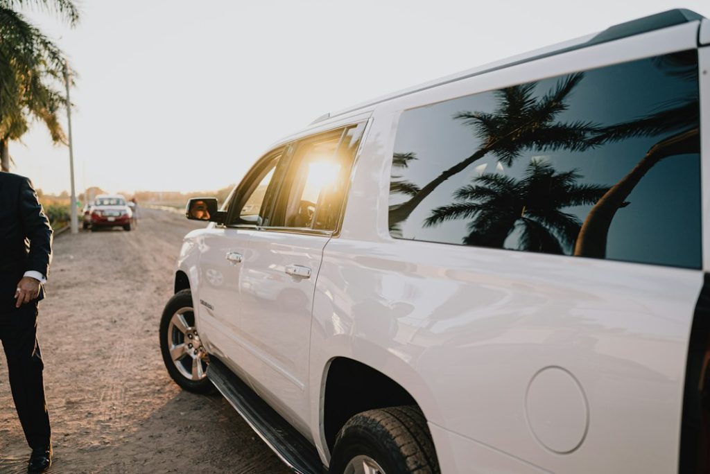 Chauffeur opening the car door for a passenger, personal driver service in Dubai